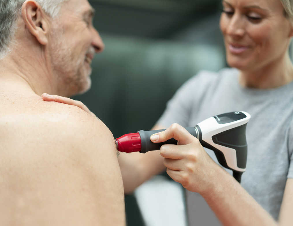 A person receiving shockwave therapy for frozen shoulder